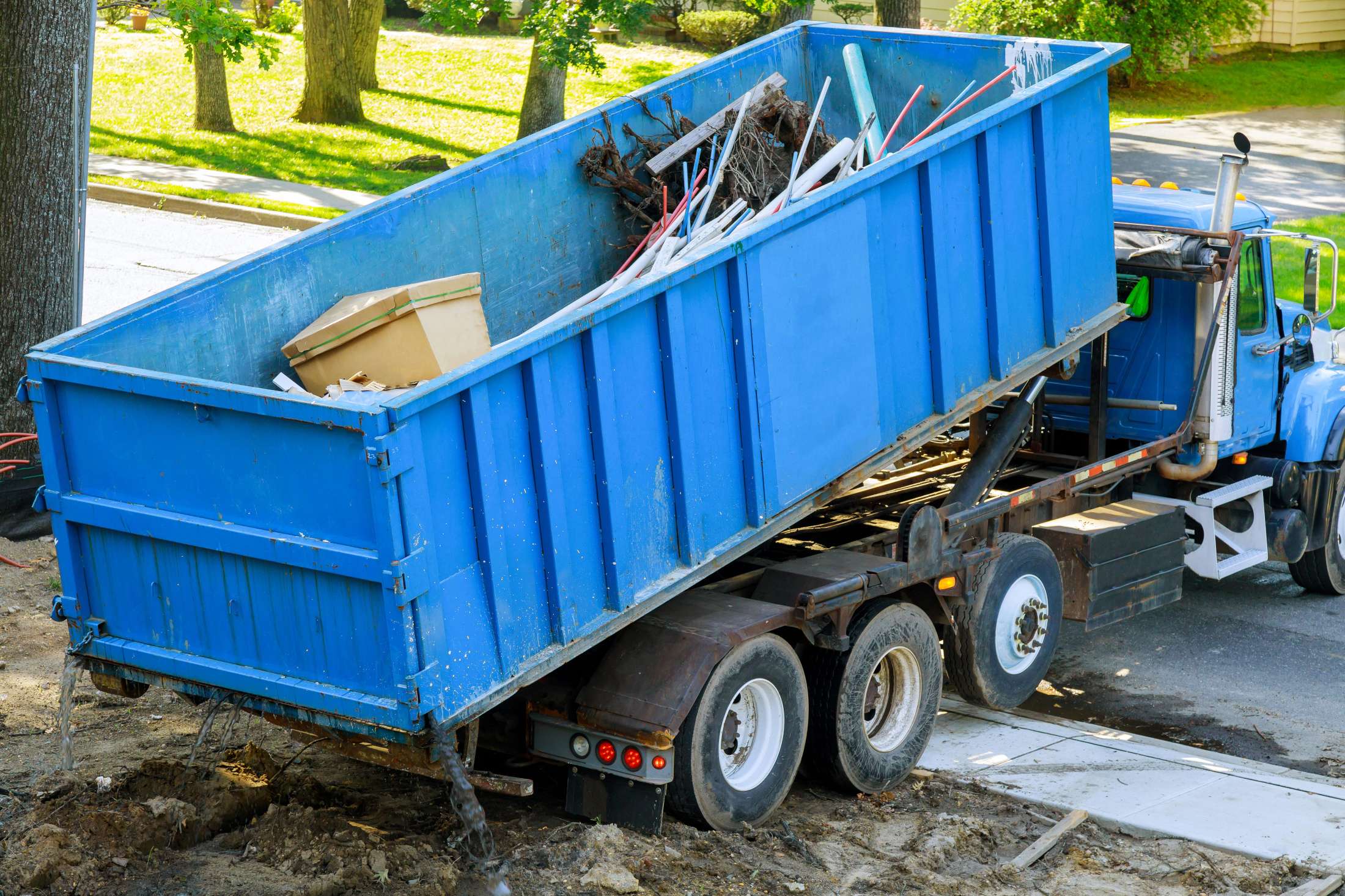 Roll-off Truck Delivering Dumpster at Job Site